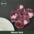 Fresh Halal Beef Shank Bone-In cross-cut pieces on dark background — 100% Halal certified, UAE delivery by Meato Hub